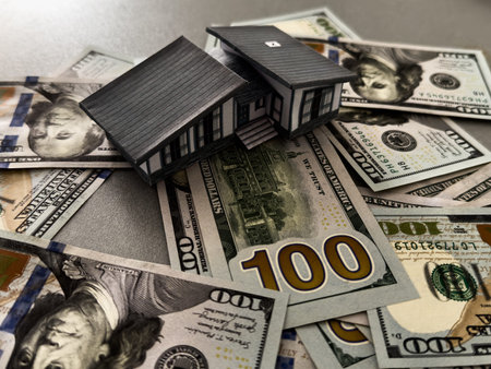 Background from money. Scattered dollars. paper house