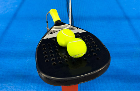 Padel tennis racket. Background with copy space. Sport court and balls.