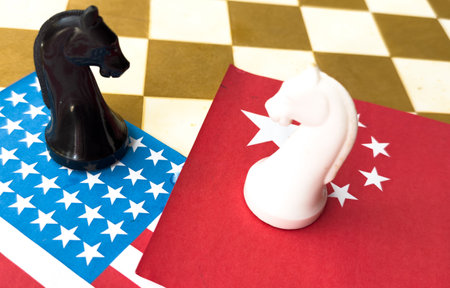 Chess game, two knights face to face on China and US national flags. Trade war concept. Conflict between two big countries, USA and China concept. Copy space.の写真素材