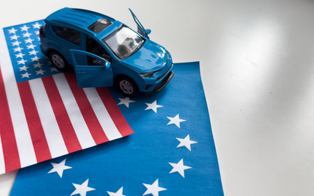 Toy cars and flags of the United States and the European Unionの写真素材