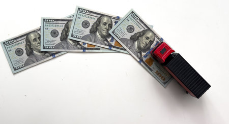 USD dollar bills, a trailer truck , depicts wasting time and paying a lot of money to buy things online called online shopping or retail e-commerce, ecommerce conceptの写真素材