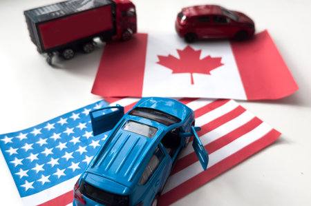toy car and flags of the USA and Canadaの写真素材