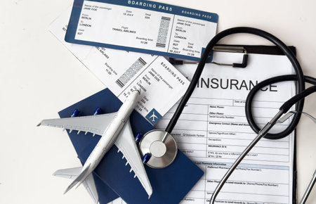 stethoscope, toy airplane on a white background. health insurance on a travel trip.の写真素材