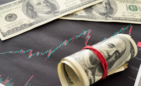 Economic and financial crisis concept. Stock market graphs and usd dollar on dark backgroundの写真素材