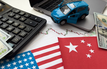 Chip shortage and US-China trade conflict. Global chip shortage crisis and China-United States trade war concept. China flag and US flag on china map and hand holding computer chip on background.の写真素材