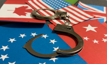 flags of different countries with handcuffs. Currency corruption in the country. Financial crimesの写真素材