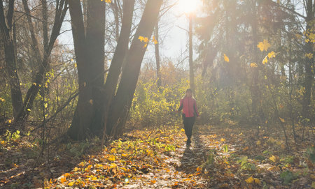 Young happy athletic woman running in nature. Copy space.の写真素材