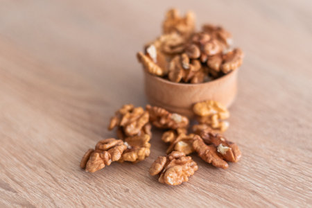 Walnuts kernels on dark desk with color background, Whole walnut in wood vintage bowl.の写真素材