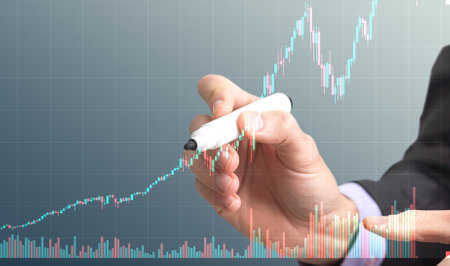Businessman with a marker on grey backgroundの写真素材