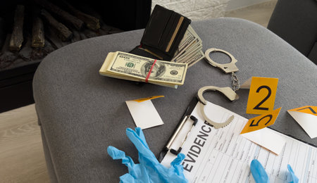 Money, handcuffs and fingerprint record sheets on wooden background, top view with space for text. Criminal investigationの写真素材