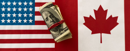 Canadian flag with american dollar billsの写真素材