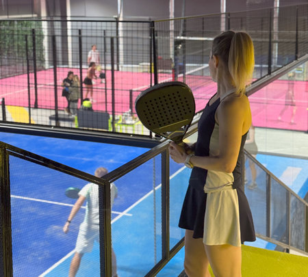 Woman in a padel court indoorの写真素材