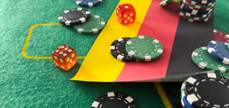 Chips from casino. germany flag. Gambling industry in germany. Casino chips are scattered on steel. Gambling business. Casinos. Gambling. Poker, roulette.の写真素材