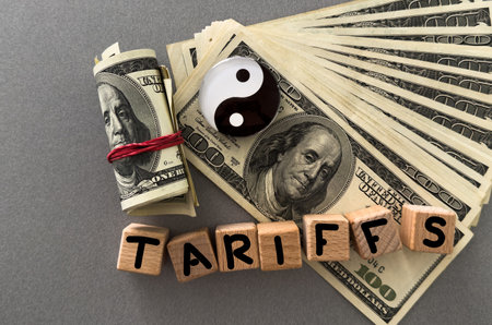 tariffs on a background of dollars with a balance symbolの写真素材