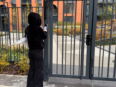 a female entering the garden through a gateの写真素材
