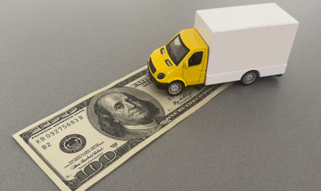 Toy car truck with money isolated on backgroundの写真素材