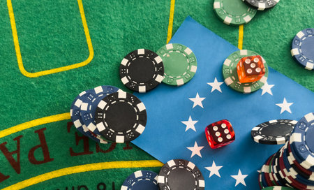Casino background. Roulette table Chips. Casino theme. High contrast image of casino roulette, poker game, dice game, poker chips on a gaming table.の写真素材
