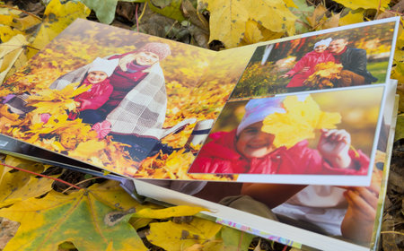 Photobook on the leaves background, closeup of photobook, family photo albumの写真素材