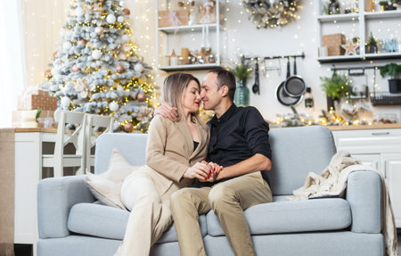 A happy couple shares a joyful moment while hanging, Christmas tree at home.の写真素材
