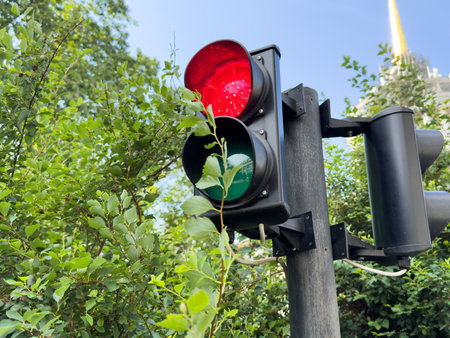 traffic light that burns red on the street nearの写真素材