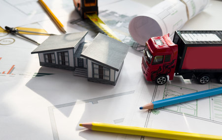 A model house and a truck on a white background.