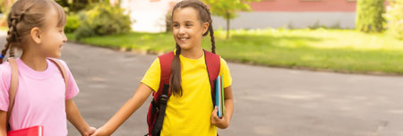 Primary Or Elementary School Students With Backpacks Outdoors At End Of Dayの写真素材