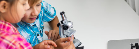 Using microscope. Children plays a scientists in lab by using equipment.の写真素材