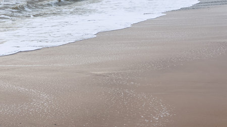 sandy beach shoreline calm ocean waves natural background, summer concept backgroundの写真素材
