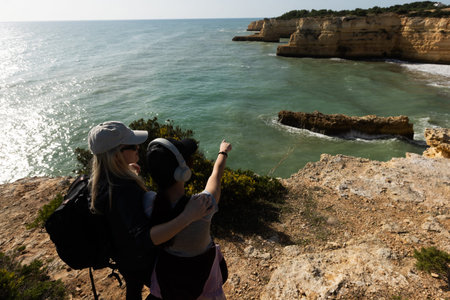 Aerial seascape and coastline cliffs of Praia do Barranco das Belharucas beach, in Algarve region in South Portugal. Praia do Barranco das Belharucas beach, Albufeira, Algarve, Portugal.の写真素材