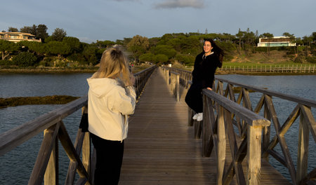 Landmark footbridge heading to famous Quinta do Lago beach, in Ria Formosa wetlands natural...
