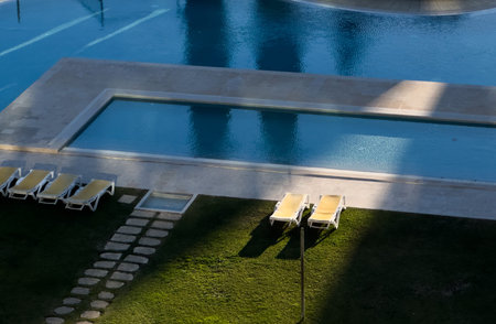 Poolside relaxation lounge chairs and privacy hedge