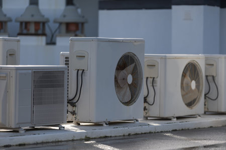 HVAC systems operate on a rooftop with industrial air conditioning units providing ventilation and cooling for commercial buildings and urban infrastructure.の写真素材