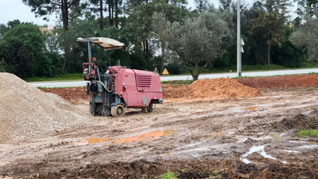 The excavator works to clear the soil and move it out of the excavation at the construction site.