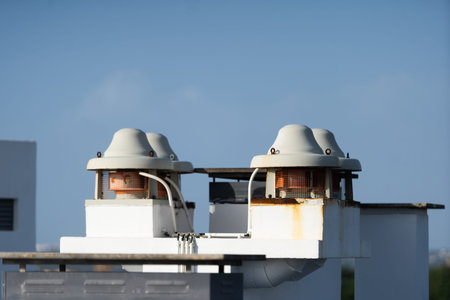 Flat roof vents with hvac unit on building with modified bitumen roofing system . Variety of metal...