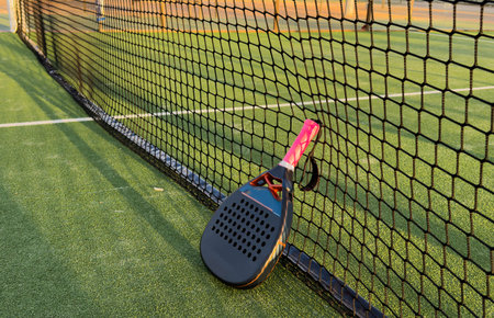 professional paddle tennis racket with natural lighting on green background. Horizontal sport theme poster, greeting cards, headers, website and appの写真素材