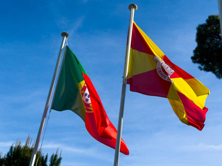 Wavy Spain and Potugal Flags and Clear Blue Sky