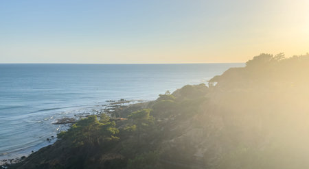 Falesia Beach, Algarve, Portugal. Golden mile beach with orange rocks, golden sand and turquoise sea. Aerial drone top view perspective. Famous travel destination in south of Portugal