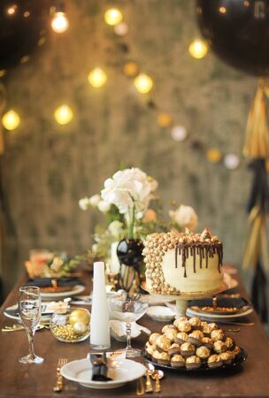 Golden cake on a wooden table with servingの写真素材