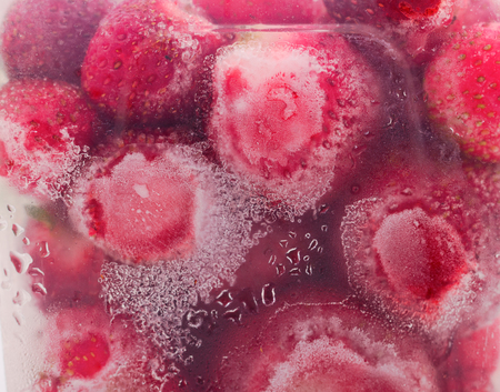 Frozen strawberries. A lot of frozen strawberries as a background.の写真素材