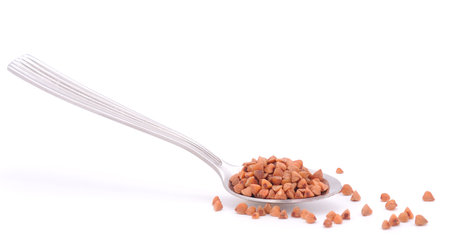 Spoon with buckwheat isolated on white background.の写真素材