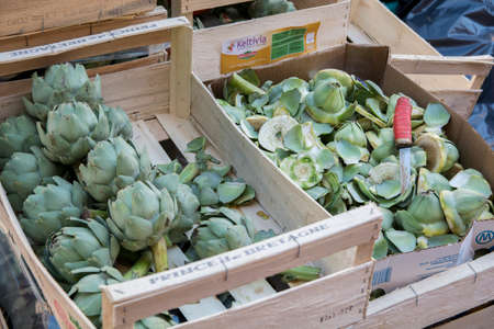 A wooden box containing Artichokes (Cynara scolymus) for sale, in a floating vegetables market, Venice, Italyの写真素材