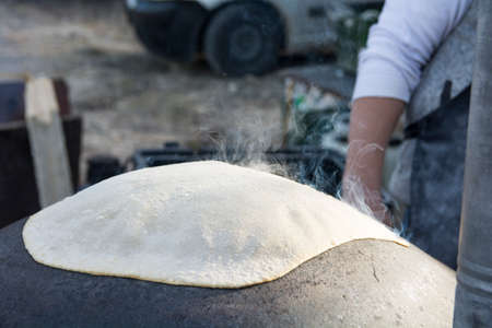 Traditional Druze Pita bread, baked on a Saj or Tava, on open fireの写真素材