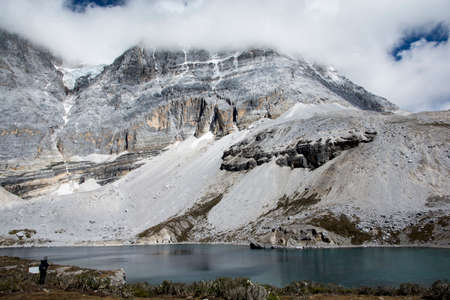 Blue Lake and snowy mountain, in the nature reserve of Yading, Sichuan, China.