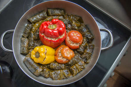 Top view of homemade traditional "Dolma",rolled vine leaves stuffed with rice, a typical Mediterranean dish, cooked in a wide potの写真素材
