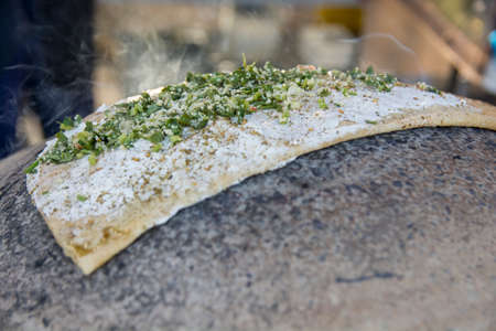 Traditional Druze Pita bread, baked on a metal Saj or Tava, with Labane cheese, a  Middetrenian...