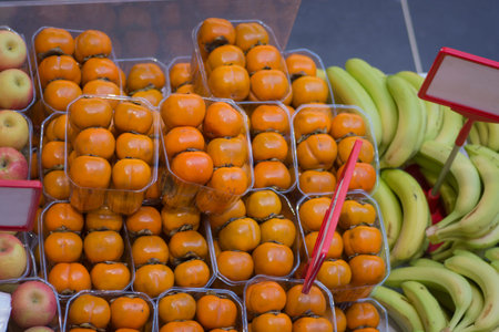 Persimmon fruit on the counter in the market, Thailand.の写真素材