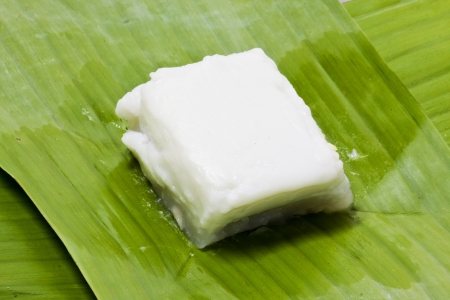 Taro custard topped with coconut layer on banana leafの写真素材