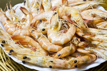 Close up boiled shrimp with shell on plate and basketの写真素材
