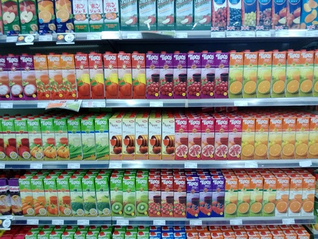 Variety of juices are shown in a supermarket shelfs in Bangkok Thailandの素材