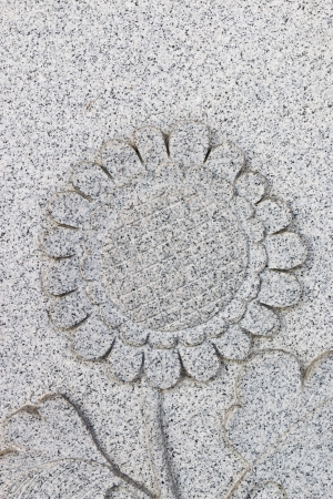 Emboss sunflower on grey wall, verticalの写真素材